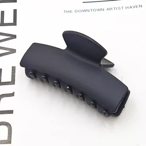 Close-up of black matte rectangular hair claw clip for elegant hairstyling
