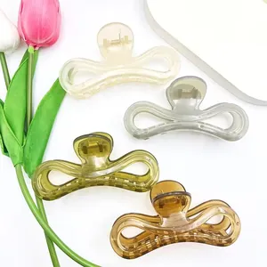 Jelly colored minimalist hair claw clips shown in amber, olive green and cream colors