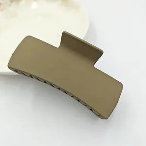 Close-up detail of a large solid square matte hair claw clip in khaki green finish