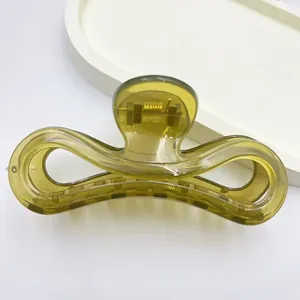 Close-up of a jelly olive green hair claw clip showing its unique translucent texture