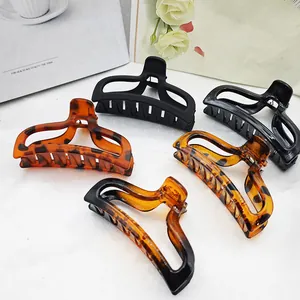 Detailed view of assorted large hair claw clips in tortoiseshell and black patterns