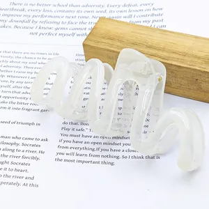Close-up of large jelly-colored wavy hair claw clip with elegant translucent finish