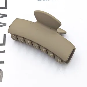 Detailed view of a matte khaki rectangular French hair claw clip for women's hairstyling