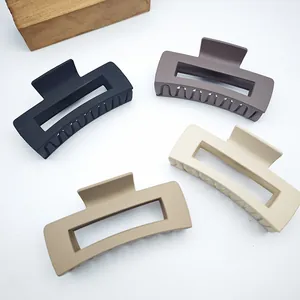 Detailed view of large matte square hair claw clips in assorted neutral earth tones