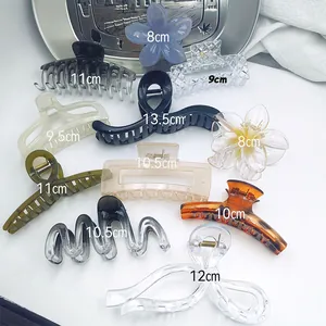 Collection of various hair claw clips in different sizes and shapes for hair styling.