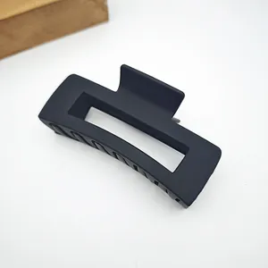 Detail view of a large matte black square hair claw clip on a clean white background.