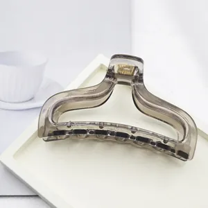 Detailed macro shot of a minimalist smoke grey translucent resin hair claw clip