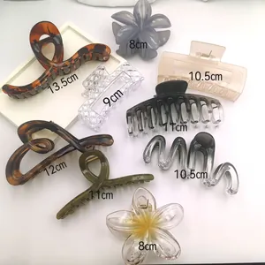 Detail view showing various sizes and styles of minimalist oversized hair claw shark clips.