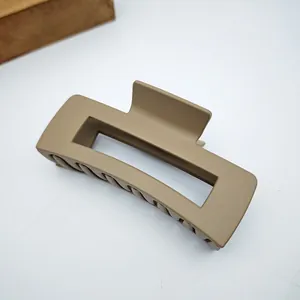 Detailed view of a matte khaki square hair claw clip featuring a sturdy spring mechanism.