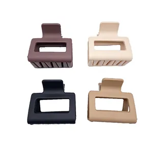 A set of four high-quality matte square hair claw clips in various earth-tone colors