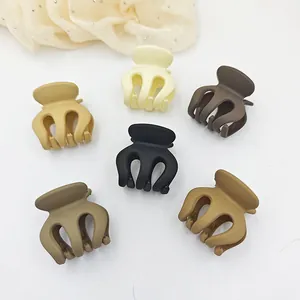 Set of 6 mini matte hair claw clips in neutral earth tones for versatile styling.