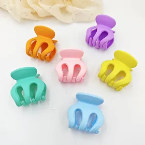 Close-up of 6 mini matte candy color hair claws for kids styling and ponytail fix