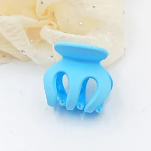 Minimalist small light blue matte hair claw clip for ponytail styling or side hair hold