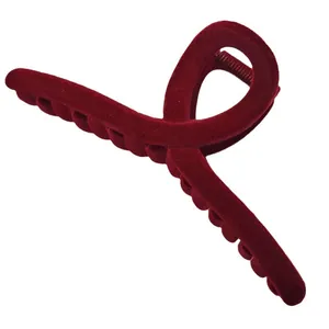 Large red velvet hair claw clip with elegant flocked finish and strong grip for women