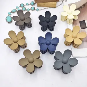 Collection of matte five-petal flower hair claw clips displayed in various dark tones