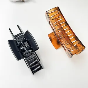 Detailed top view of large black and tortoiseshell hair claw clips for thick hair