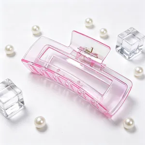 Close-up of large transparent pink UV plated square hair claw clip on white background