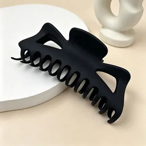 Close-up view of the matte black finish and sturdy teeth of this large hair claw clip