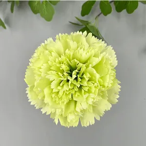 Macro view of a lime green artificial carnation flower head for wedding DIY decor.