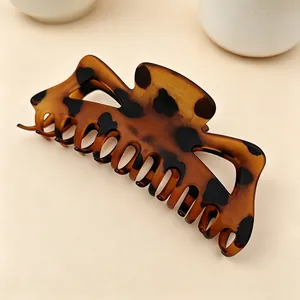 Close-up shot of a large matte tortoiseshell leopard print claw clip for thick hair