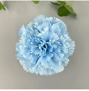 Detailed top view of a light blue artificial carnation flower head with delicate petals