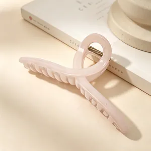 Detailed view of an elegant 13cm large pink PC hair claw clip for thick hair styling