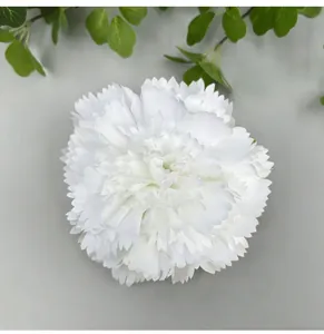 Top view detail of a realistic white artificial carnation flower head for wedding decor.