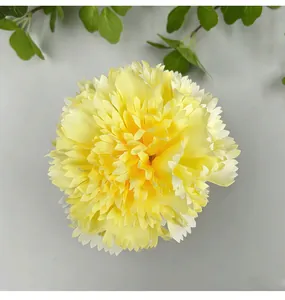 Detailed view of a vibrant yellow artificial carnation flower head for DIY decor.