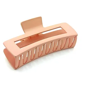 Detail view of a large matte peach square hair claw clip for thick hair styling