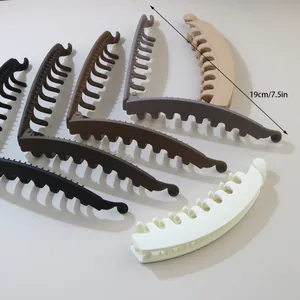 Detailed close-up of large matte banana hair clips with 19cm length measurement