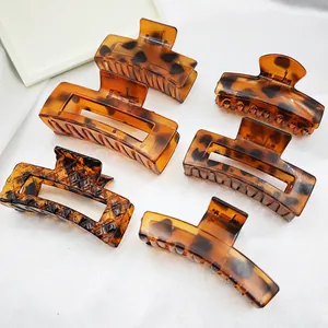Detailed view of assorted large leopard print claw clips for stylish hair styling