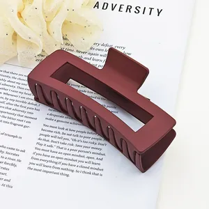 Detailed view of large matte burgundy rectangular hair claw clip for thick hair styling