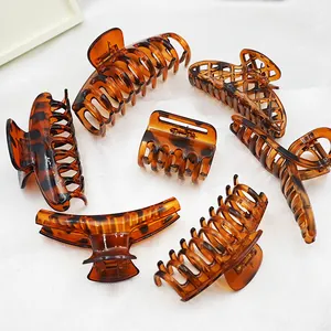 Detailed view of various large leopard print and tortoise shell plastic hair claw clips