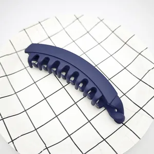 Detailed view of a navy blue matte banana hair clip for high ponytail on grid plate