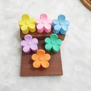 Close-up of colorful matte flower-shaped hair claws in vibrant pastel macaroon tones
