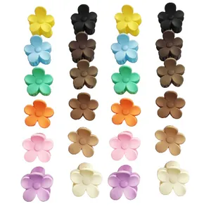 Detailed close-up of small flower hair claw clips in Maillard and Macaron matte colors