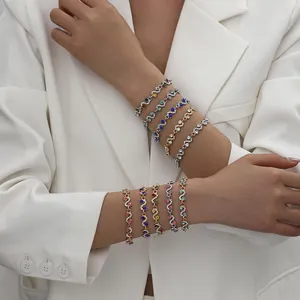 Detailed close-up showing stacked colorful zircon wavy bracelets for women on a model's arm