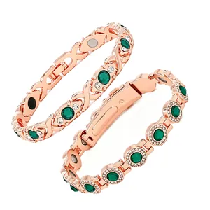 Close-up detail of rose gold magnetic therapy bracelets featuring green gemstones