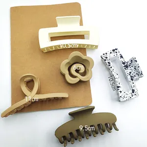 Detailed size dimensions of various matte hair claw clips in neutral earth tones