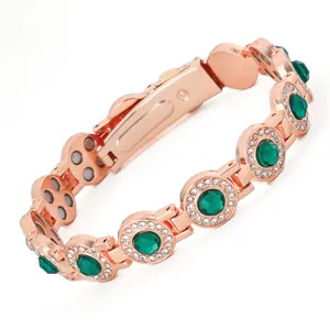 Rose gold magnetic bracelet with green gemstones and sparkling rhinestones for women.