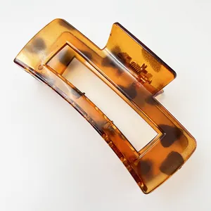 Close-up of large tortoise shell hair claw clip with leopard pattern