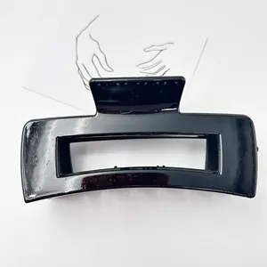 Detailed macro view of a large glossy black rectangular hair claw clip for hair styling