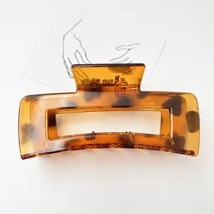 Macro detail of the semi-transparent amber tortoiseshell pattern on a large resin hair claw