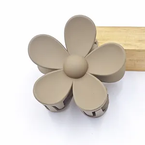 Close-up of matte khaki flower hair claw clip with five-petal design
