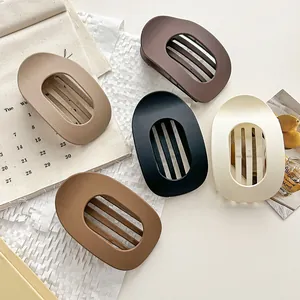 Set of five large matte frosted hair claw clips in various neutral earth tones detail view