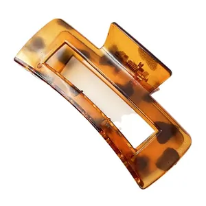 Large tortoise shell hair claw clip with a transparent leopard print pattern design