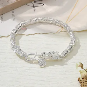 Close-up detail of a silver retro dragon head bracelet featuring an intricate braided link chain