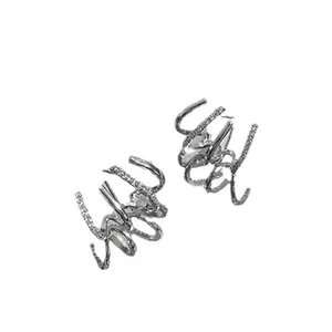 Exaggerated silver claw earrings with rhinestone pavé, stylish punk jewelry for women.