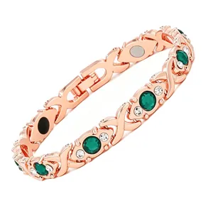 Detailed view of luxury rose gold magnetic bracelet with emerald green crystals.