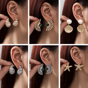 Detailed view of six styles of ocean-themed earrings including starfish and gold shells